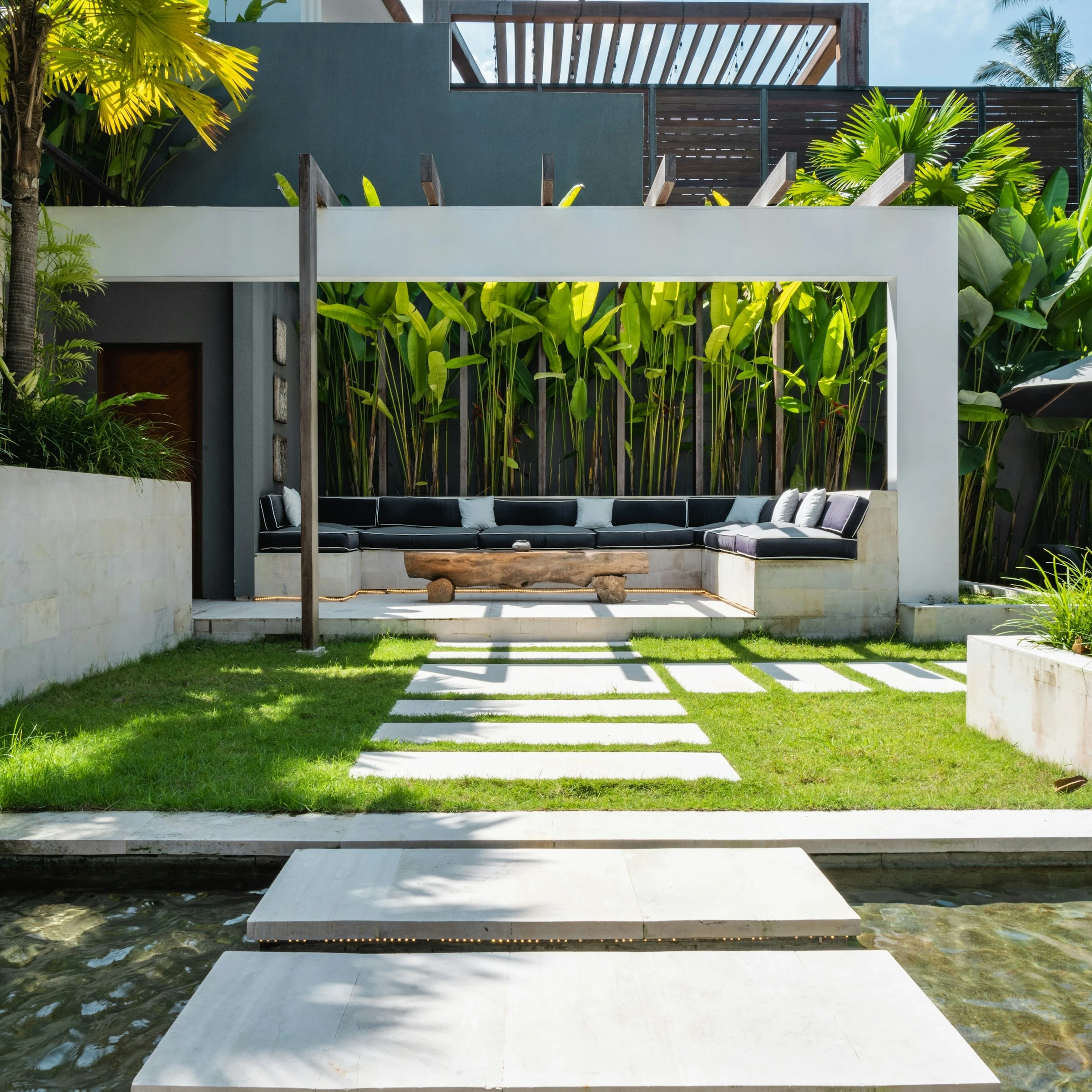 Modern villa courtyard with a reflecting pool and tropical landscaping